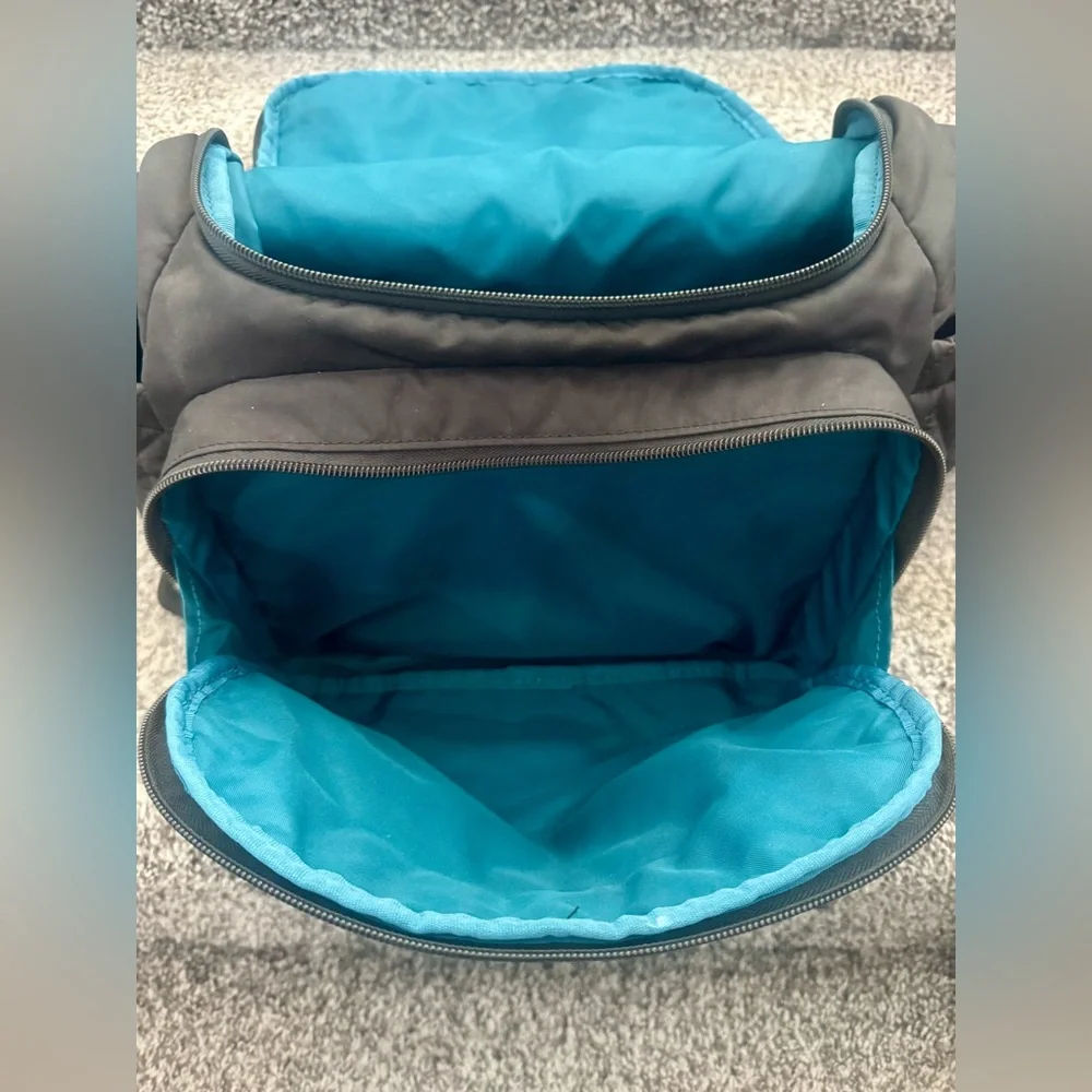 Skip Hop Forma Diaper Backpack. Black Exterior with Teal Interior.